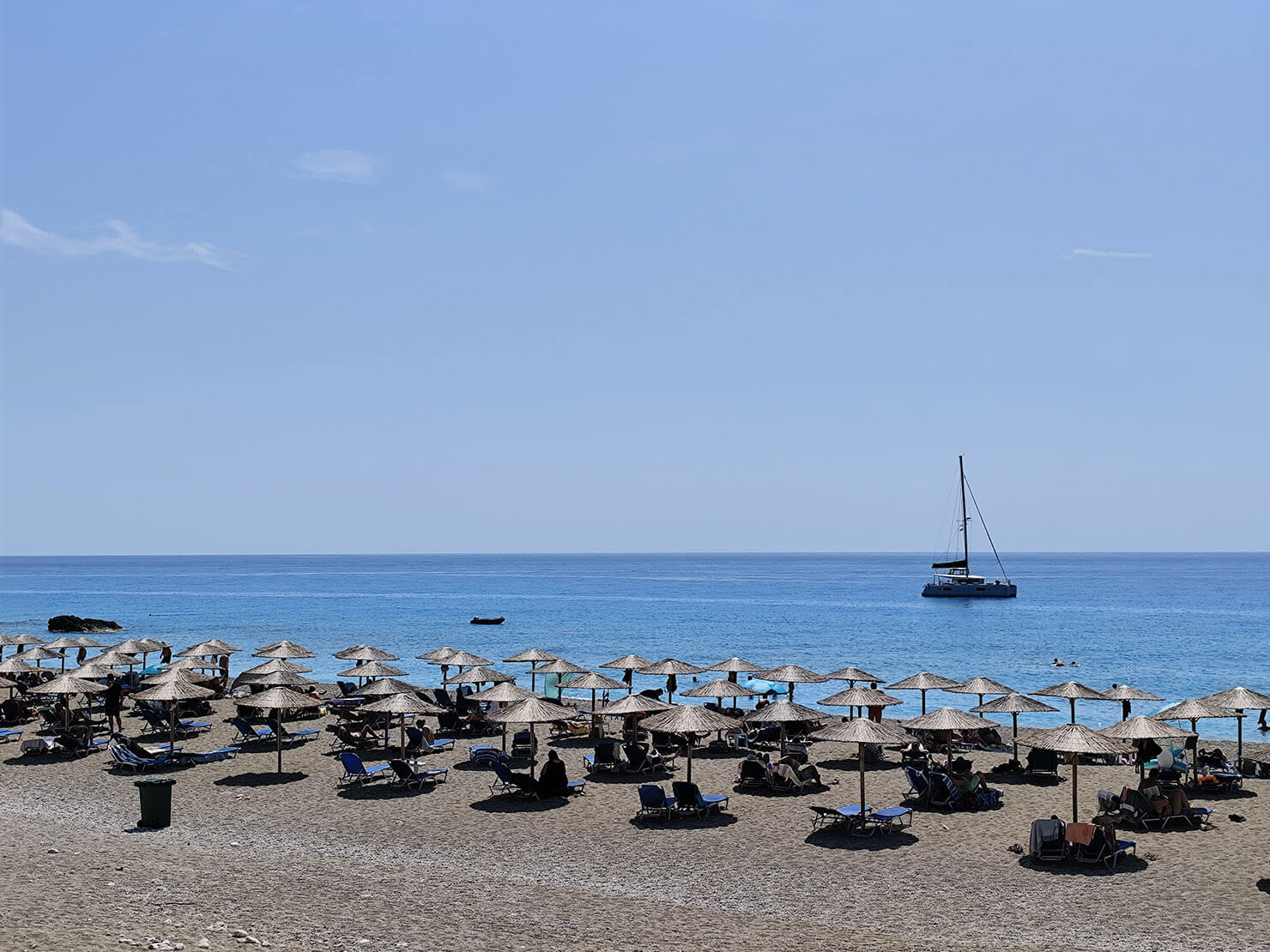 The long, expansive shoreline of Gialos Beach on Lefkada's west coast, with its turquoise waters and dramatic cliffs.