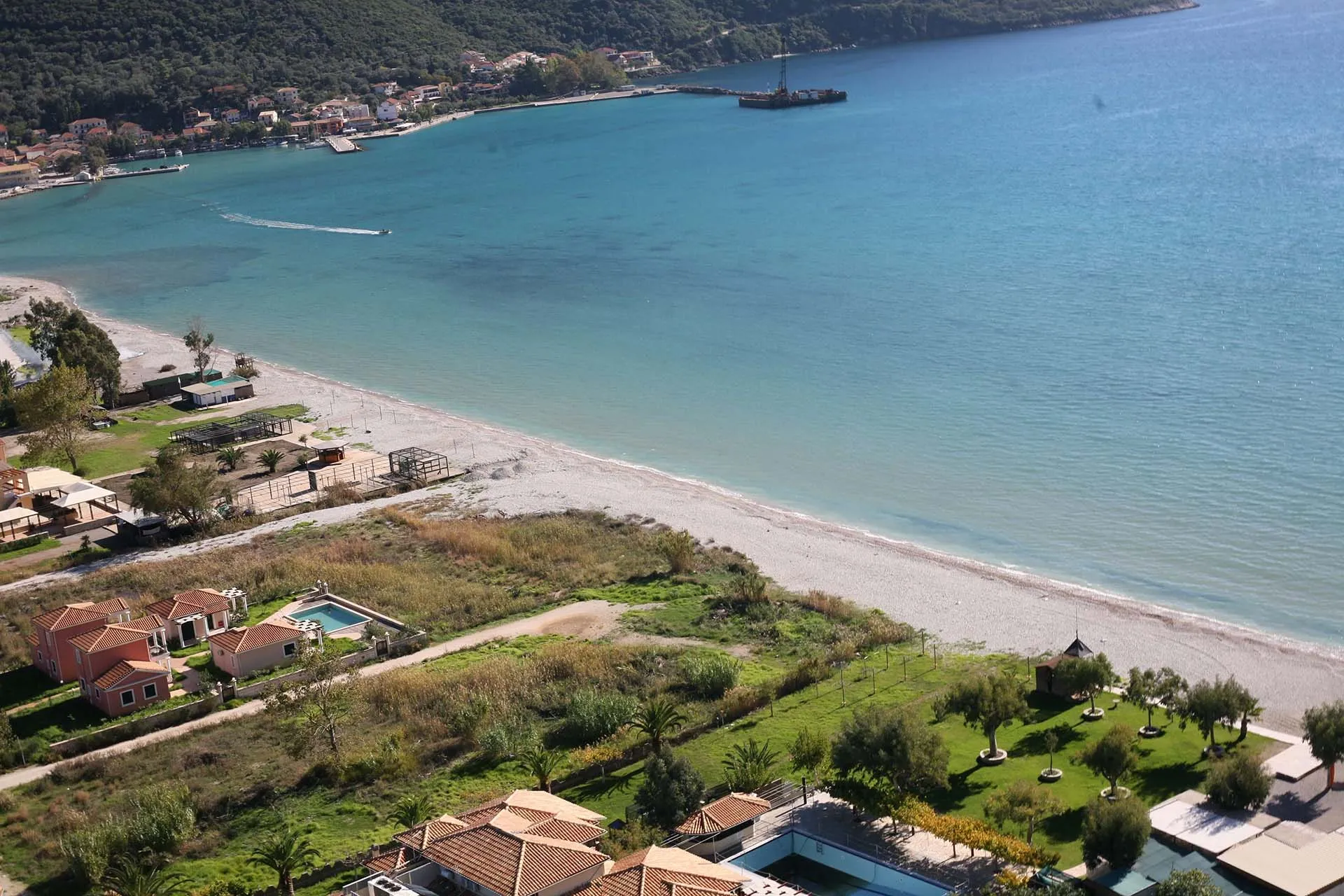 Hundreds of colorful windsurf sails on the water at the world-famous Vasiliki Beach in Lefkada.