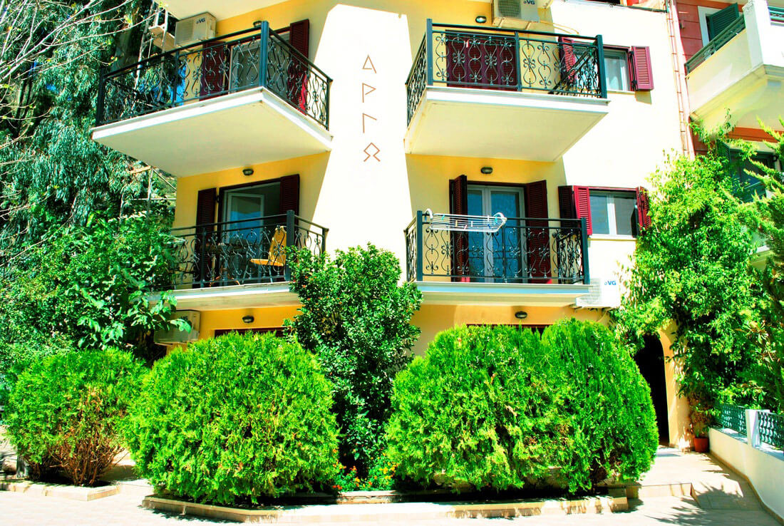 The inviting exterior of Argo Apartments in Vasiliki, nestled in a green and peaceful environment.