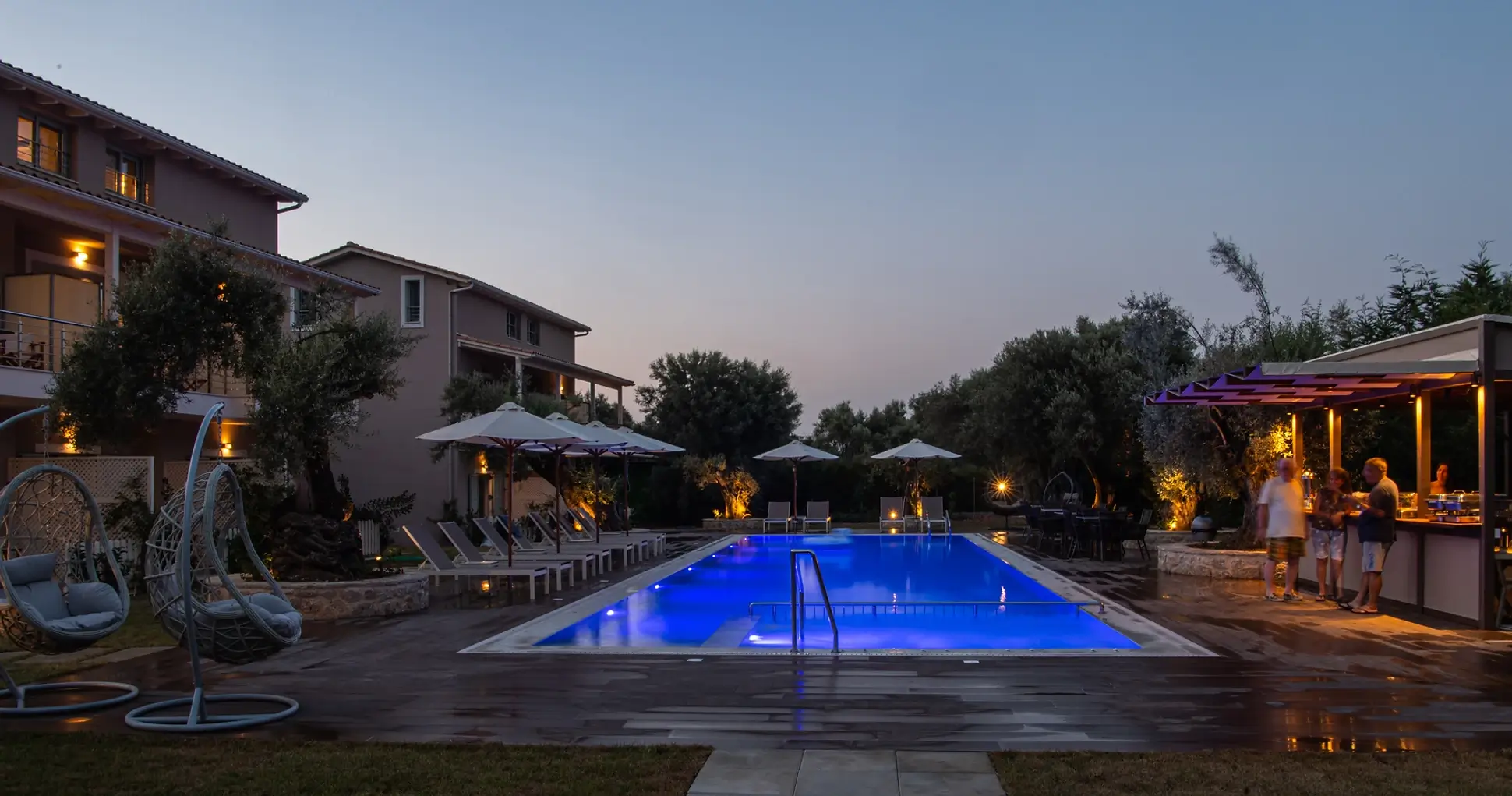 The beautiful swimming pool and lush olive garden of Summer Dream Studios & Apartments in Apolpena, Lefkada.