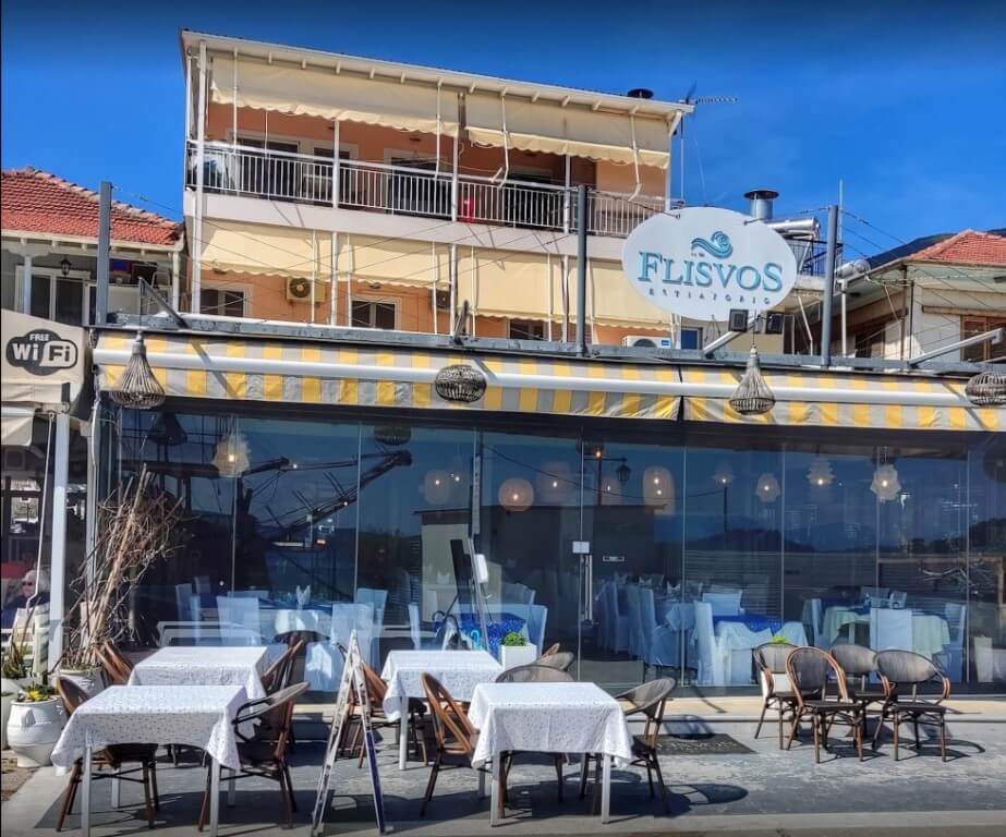 Flisvos Restaurant in Nidri, offering a classic Greek dining experience with views towards Skorpios and Madouri islands.