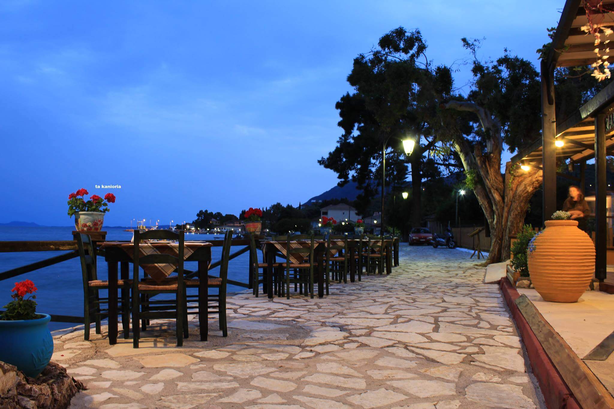 Kanioria Fish Taverna in Lygia, with tables set beautifully by the water in the charming fishing harbour.