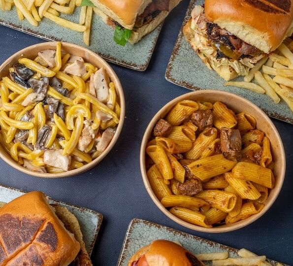 A delicious plate of fresh pasta and a juicy smashed burger served at Pastino in Lefkada Town.