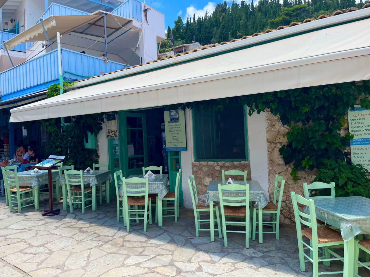 The charming entrance of Portoni Restaurant, nestled in the picturesque alleys of Agios Nikitas, Lefkada.